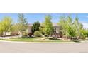 A nicely landscaped front exterior features healthy green trees and well-maintained lawn at 4519 Silver Mountain Loop, Broomfield, CO 80023