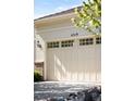 A beige garage door with inset windows is adorned with the house numbers 4519 at 4519 Silver Mountain Loop, Broomfield, CO 80023