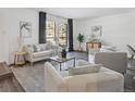 Light-filled living room with large windows and comfy seating at 10360 E Jewell Ave # 95, Aurora, CO 80247