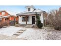 Charming home with a cozy front porch and snowy front yard, complete with inviting curb appeal at 1375 Perry St, Denver, CO 80204