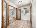 Inviting foyer with tiled floor and decorative glass paneled doors leading to living areas at 10058 Lewis St, Broomfield, CO 80021