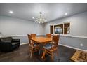 Cozy dining area with modern lighting and gray walls adjacent to large window and open floor plan at 13464 W Virginia Dr, Lakewood, CO 80228