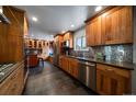 Well-appointed kitchen with stainless steel appliances, custom cabinets, and stylish backsplash at 13464 W Virginia Dr, Lakewood, CO 80228