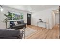 Inviting living room featuring hardwood floors, a large window, and a stylish couch at 6068 Lee St, Arvada, CO 80004