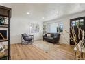 A bright and modern living room with new flooring, fresh paint and updated lighting at 6068 Lee St, Arvada, CO 80004