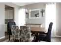 Elegant dining room featuring a wooden table, stylish chairs, and decorative accents at 640 E Fremont Pl, Littleton, CO 80122