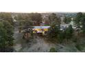 An aerial view of a charming home nestled among evergreen trees at 7841 Deertrail Dr, Parker, CO 80138