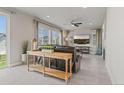Open-concept living room with large windows, tile floors, a ceiling fan, and comfortable seating at 7380 S Shady Grove Way, Aurora, CO 80016