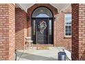 Elegant front entry with black door and wreath at 221 Mulligan Lake Dr, Mead, CO 80542