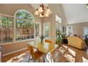 Cozy dining area with large windows and ample natural light is adjacent to the open living room at 2252 S Yosemite Cir, Denver, CO 80231