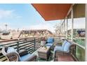 Relaxing balcony area featuring comfortable seating with views of the surroundings and beautiful potted plants at 1401 Delgany St # 204, Denver, CO 80202