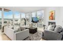 Bright and airy living room featuring floor-to-ceiling windows with city views, modern decor, and comfortable seating at 1401 Delgany St # 204, Denver, CO 80202