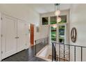 Welcoming entryway with black tiled floors, white walls, and modern lighting fixtures at 5 Hillside Dr, Wheat Ridge, CO 80215