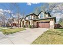 Charming two-story home with a well-manicured lawn and a spacious driveway at 2411 S Garfield St, Denver, CO 80210