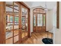 Inviting foyer with hardwood floors, elegant chandelier, and view of the office through glass French doors at 2411 S Garfield St, Denver, CO 80210
