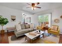Inviting living room with hardwood floors, a ceiling fan, and access to a private balcony at 1201 Race St # 10, Denver, CO 80206