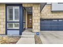 Close-up of the home's front entrance, highlighting the door, windows, and stone facade at 10910 Touchstone Loop, Parker, CO 80134