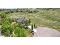 Expansive property featuring a stunning home, lush greenery, and easy access to nearby trails at 14958 Wistera Way, Broomfield, CO 80023