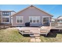 The backyard has a spacious deck, perfect for outdoor entertaining and relaxation at 4834 S Wenatchee St, Aurora, CO 80015