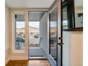 Condo entrance with glass door, transom window and exterior view at 2400 S Delaware St # 1, Denver, CO 80223