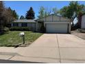 Charming single Gathering home with a well-manicured lawn and a two-car garage at 16180 E Flora Pl, Aurora, CO 80013