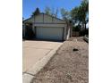Charming single Gathering home with a well-manicured lawn and a two-car garage at 16180 E Flora Pl, Aurora, CO 80013