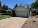 Charming single Gathering home with a well-manicured lawn and a two-car garage at 16180 E Flora Pl, Aurora, CO 80013