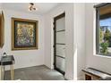 A well-lit foyer featuring modern decor, artwork and dark metal trimmed glass door at 1763 S Williams St, Denver, CO 80210