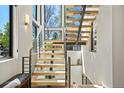 Modern staircase featuring wood treads, metal railings and abundant natural light at 1763 S Williams St, Denver, CO 80210