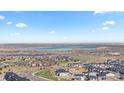 Expansive aerial view of the neighborhood, highlighting community layout and nearby lake at 17213 W 93Rd Pl, Arvada, CO 80007