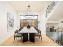 Bright dining room with modern chandelier, staircase and large windows at 535 Albion St, Denver, CO 80220