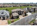 A grand two-story home with a tile roof is situated on a corner lot near a lush green space at 9099 E Harvard Ave, Denver, CO 80231