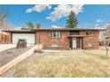 Beautiful brick home with manicured landscaping and attached two car garage, located on a corner lot at 6614 Everett St, Arvada, CO 80004