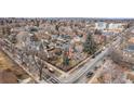 Aerial view of a neighborhood featuring a Victorian home with a turret and a tree-lined street at 3015 Lowell Blvd, Denver, CO 80211