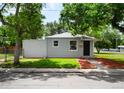 Beautifully landscaped front yard with mulch and a freshly painted exterior at 1180 Newark St, Aurora, CO 80010