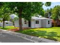 A cozy home with a well-manicured lawn and fresh mulch at 1180 Newark St, Aurora, CO 80010