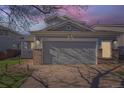Charming two-story home with a two-car garage under a sunset sky at 20521 E Bellewood Pl, Aurora, CO 80015