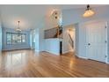 Bright and airy living room with hardwood floors and staircase at 20521 E Bellewood Pl, Aurora, CO 80015