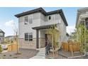 Beautiful two-story house with stone accents and a well-maintained lawn at 6225 N Nepal Ct, Aurora, CO 80019