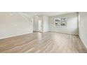 Open living space features natural light, light-colored walls, and light wood-look flooring throughout at 6225 N Nepal Ct, Aurora, CO 80019