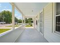 Long, airy covered porch with views of the neighborhood, perfect for enjoying the outdoors at 4465 S Bannock St, Englewood, CO 80110