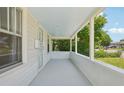 Spacious covered porch featuring white pillars and ample room for seating and relaxation at 4465 S Bannock St, Englewood, CO 80110