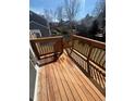A clear wooden deck with handrails overlooking a grassy backyard and surrounding neighborhood at 5971 S Tabor St, Littleton, CO 80127