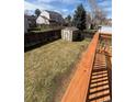 Spacious backyard featuring a storage shed and bordered by a wooden fence, offering privacy at 5971 S Tabor St, Littleton, CO 80127