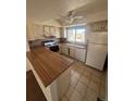Functional kitchen featuring light cabinets, laminate countertops, and standard appliances at 5971 S Tabor St, Littleton, CO 80127