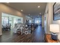 Inviting entryway featuring hardwood floors and seamless flow into dining and living spaces at 23579 E Swallow Cir, Aurora, CO 80016