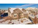 Beautiful two-story home with a snow-covered front yard and attached garage at 23579 E Swallow Cir, Aurora, CO 80016