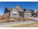 Attractive home with stone and siding exterior, two-car garage, and beautifully landscaped front yard at 23579 E Swallow Cir, Aurora, CO 80016