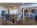 Spacious living area showcasing hardwood floors and an open layout to the kitchen and dining areas at 23579 E Swallow Cir, Aurora, CO 80016