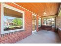 Charming front porch with brickwork, a hanging swing, and a view of the neighborhood at 4945 Perry St, Denver, CO 80212